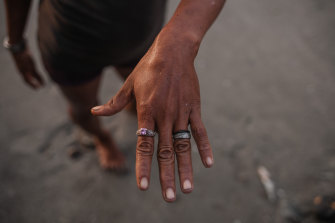 A woman wears a ring that her husband found on the shores of Guaca, Venezuela.