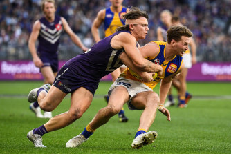 Fremantleâ€™s Caleb Serong, left, tackles Alex Witherden. 