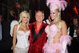 Holly Madison, on the left, pictured with Hugh Hefner and Anna Nicole Smith in 2004, said she was groomed and abused by the Playboy magazine founder. 