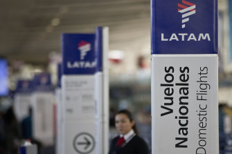 An agent of LATAM airlines stands by the counters at the airport in Santiago, Chile. 