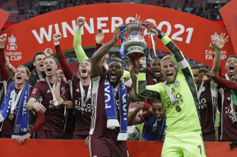 Leicester’s goalkeeper Kasper Schmeichel, right, and Wes Morgan hold the trophy aloft at the end of the FA Cup final soccer match between Chelsea and Leicester City at Wembley Stadium.