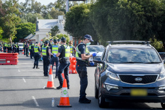 Victoria Police officers stop motorists from NSW at Wodonga on Monday morning. 