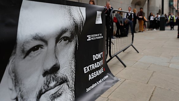 People queue at the entrance of the Old Bailey court in London.