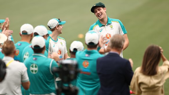 Cameron Green receives his Baggy Green cap, watched by partner Emily Redwood and father Gary Green.