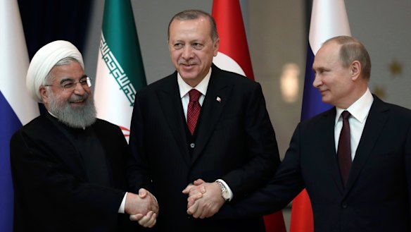 From left: Iran's leader Hassan Rouhani, Turkey's Recep Tayyip Erdogan and Vladimir Putin lock hands during discussions earlier this year on Syria's future.