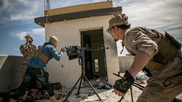Fighters of Libya's UN-backed Government of National Accord fire at the forces of the led by Khalifa Haftar in southern Tripoli.