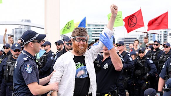 Police arrest activists from the Extinction Rebellion group after they took over the William Jolly Bridge on October 11.