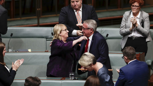 Wayne Swan is congratulated by Jenny Macklin, who is also retiring from politics. 