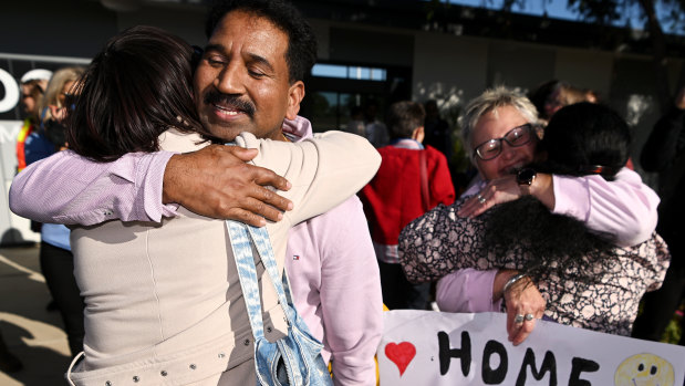 Nades and Priya embrace supporters after their arrival in Biloela.