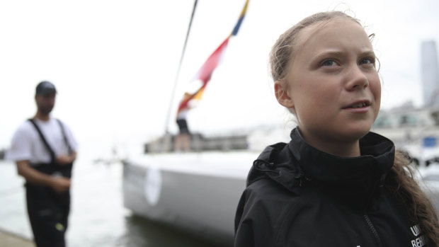 Swedish climate activist Greta Thunberg talks to reporters after arriving in New York via ship. 