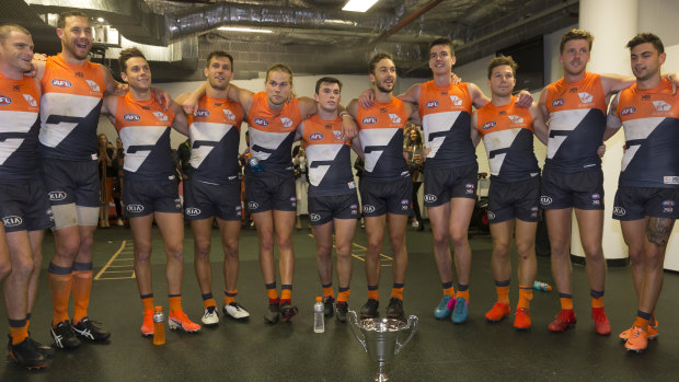 Winners are grinners: GWS Giants players celebrate their big 41-point win over Sydney.