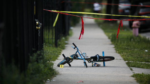 Evidence markers sit at the scene where a boy was killed after being shot in the abdomen while riding his bike in Chicago last year.