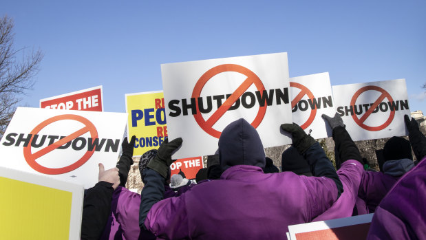 Demonstrators rally against a partial government shutdown at a protest hosted by the National Air Traffic Controllers Association on Capitol Hill in Washington.