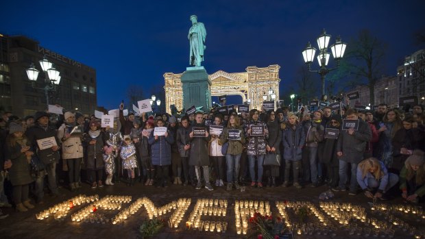 People commemorate the victims of Sunday's fire in a shopping mall in Kemerovo, Siberia, in Moscow on Tuesday.