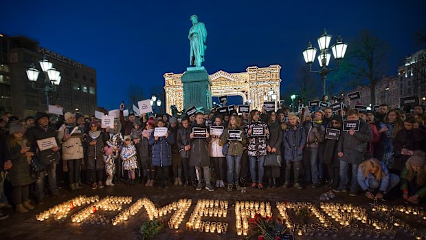 People commemorate the victims of Sunday's fire in a shopping mall in Kemerovo, Siberia, in Moscow on Tuesday.