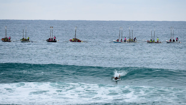 The burial at sea at Currumbin Beach, in which the ashes of 33 servicemen were scattered on the waves by local rowers from surf lifesaving clubs. 