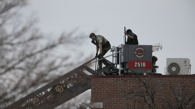 Police work on the scene outside of a King Soopers grocery store where a shooting took place in Boulder, Colorado. 