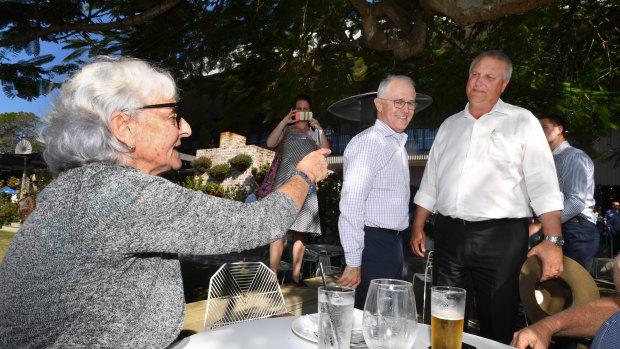 Prime Minister Malcolm Turnbull and LNP candidate for Longman, Trevor Ruthenberg, cop some advice from local Toni Lea while out campaigning on Friday. 