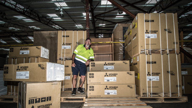 Harvey Norman Fyshwick warehouse manager Robert Mason, pictured among the air conditioners,
says there has been a run on the units in the hot weather.