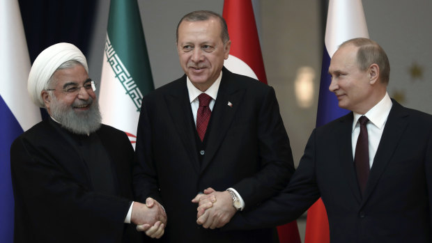 From left: Iran's leader Hassan Rouhani, Turkey's Recep Tayyip Erdogan and Vladimir Putin lock hands during discussions earlier this year on Syria's future.