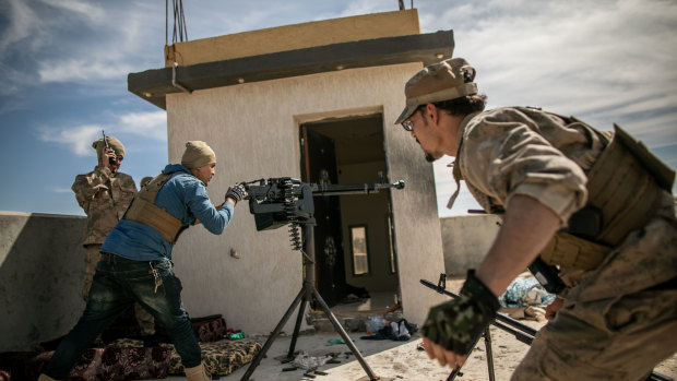 Fighters of Libya's UN-backed Government of National Accord fire at the forces of the led by Khalifa Haftar in southern Tripoli.