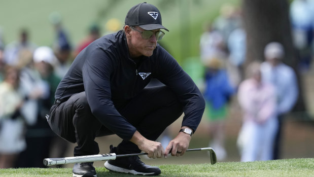 Phil Mickelson lines up a putt.