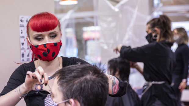Hairdressers work at a salon that opened on May 4 for the first time since March, in Berlin, Germany. 