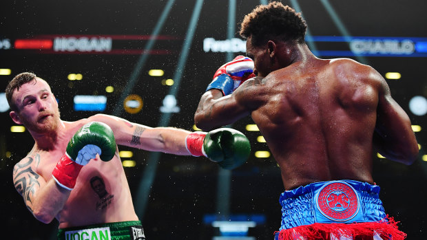 Jermall Charlo punches Dennis Hogan  during their WBC World Middleweight Championship at Barclays Center.