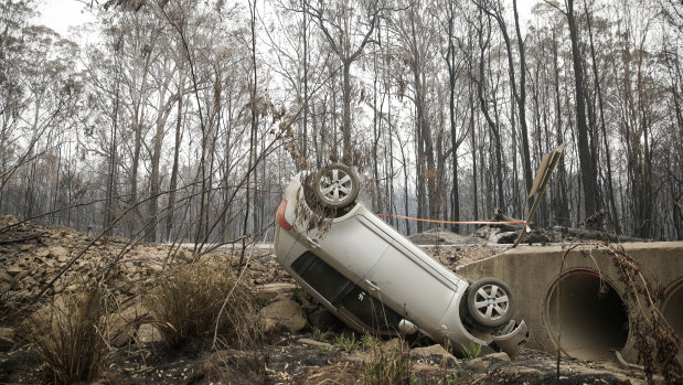 An overturned car in Nymboida which was ravaged by fires last week.