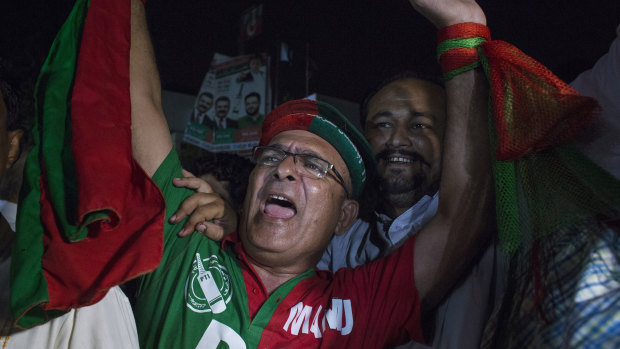 Supporters of Imran Khan, head of the Pakistan Tehreek-e-Insaf (PTI), also known as Movement for Justice, celebrate.