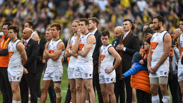 The Giants watch on as the Tigers celebrate during the post-match presentation.