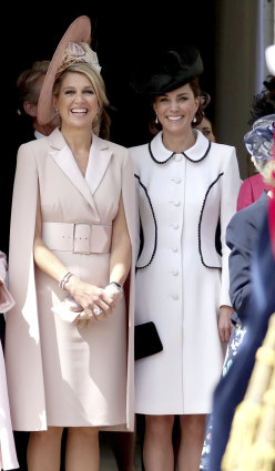 Queen Maxima of the Netherlands and the  Duchess of Cambridge stand together as they watch the annual Order of the Garter Service at St George's Chapel, Windsor Castle.