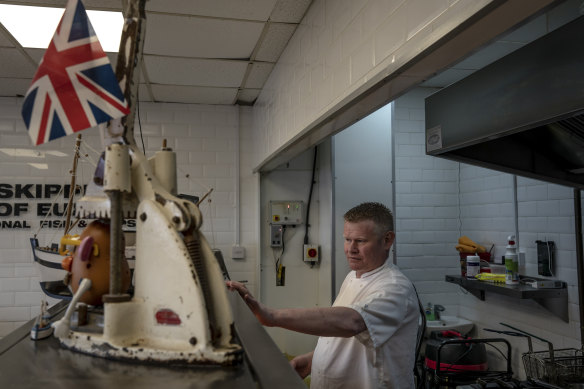 Andrew Cook, the president of the National Federation of Fish Friers, at work in his fish-and-chips shop in Euxton, England.