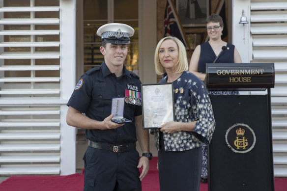 Constable Rolfe receiving a bravery cross in 2019 from NT Administrator Vicki O’Halloran.