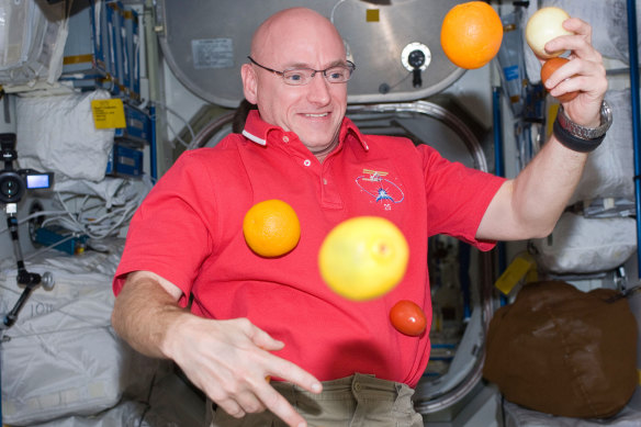 A photo provided by NASA shows astronaut Scott Kelly with fresh fruit aboard the International Space Station in 2010. 