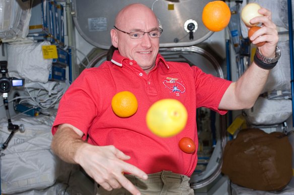 A photo provided by NASA shows astronaut Scott Kelly with fresh fruit aboard the International Space Station in 2010. 