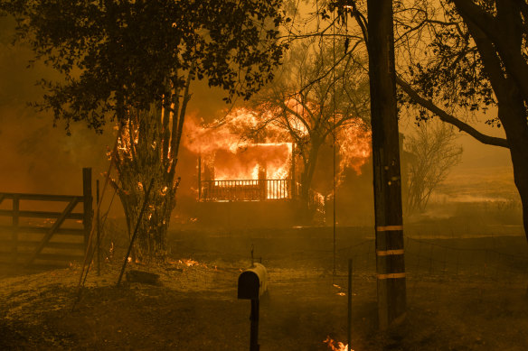 A home burns along Cherry Glen Road during the LNU Lightning Complex fire in Vacaville, California. More than 100,000 people have been evacuated from the area.