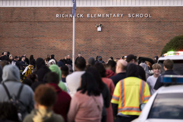Students and police gather outside of Richneck Elementary School after the shooting.