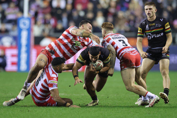 Taylan May takes the ball into the Wigan defence.