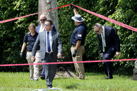 Law enforcement officials work outside of the Trump International Golf Club after the apparent assassination attempt.