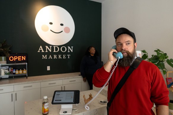 Customer Trevor Owens speaks with Luna while making a purchase at Andon Market in San Francisco