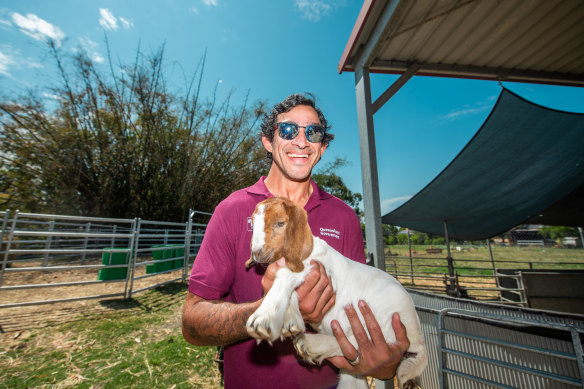 Johnathan Thurston holds a goat as he kicks off Get Ready Queensland Week at Corinda State High School on Tuesday.