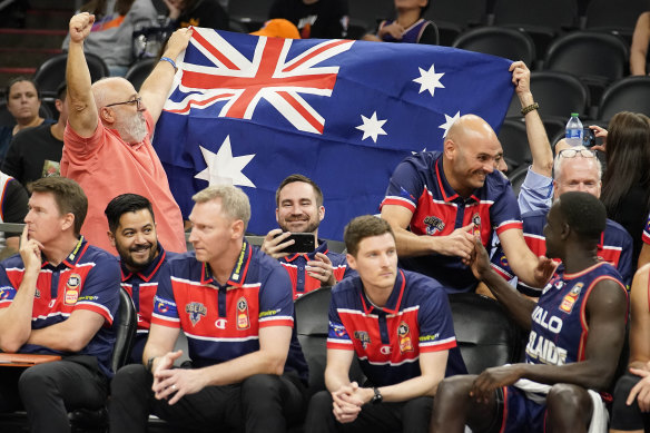 Australian fans celebrate behind the 36ers’ bench.