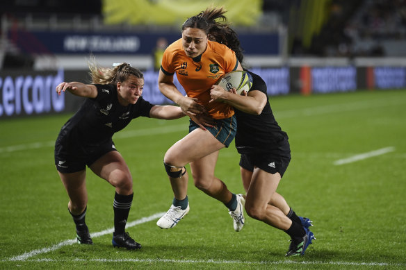 Bienne Terita charges past Black Ferns Renee Holmes and Portia Woodman to score in Australia’s loss to open the World Cup.
