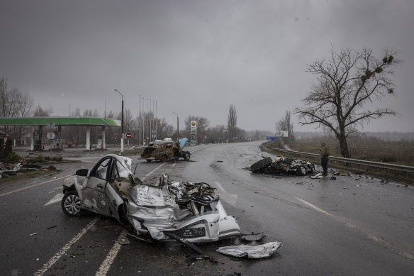 Cars lay crushed in the middle of the main road leading out of Bucha, Ukraine, on Sunday.