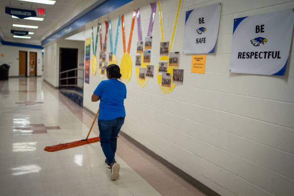 Custodian Angelica Riz, who was detained during the 2018 ICE raid, sweeps the floors of O’Neill Elementary School. 