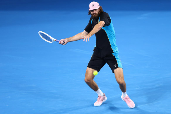 Reilly Opelka plays a forehand in his quarter-final match against Novak Djokovic.