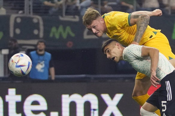 Harry Souttar heads past Johan Vasquez to score Australia’s first goal.