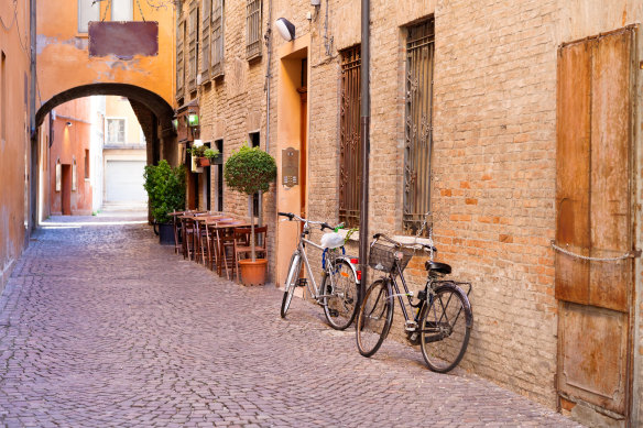 Ferrara and a cobbled (and empty) street at its centre,