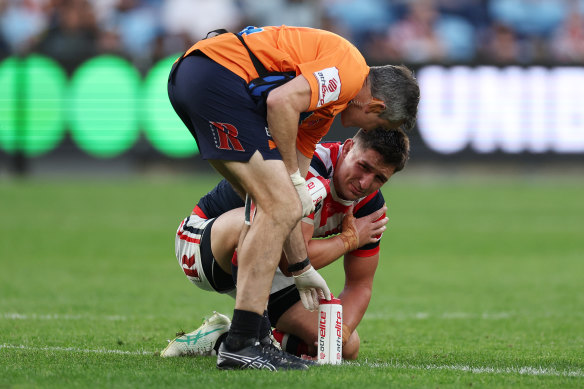 Victor Radley with a Roosters’ trainer after suffering a shoulder injury.